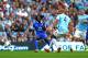 MANCHESTER, ENGLAND - OCTOBER 05: Romelu Lukaku of Everton scores the opening goal as Vincent Kompany of Manchester City closes in during the Barclays Premier League match between Manchester City and Everton at Etihad Stadium on October 5, 2013 in Manche
