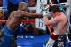 LAS VEGAS, NV - SEPTEMBER 14: (L-R) Floyd Mayweather Jr. throws a right at Canelo Alvarez during their WBC/WBA 154-pound title fight at the MGM Grand Garden Arena on September 14, 2013 in Las Vegas, Nevada. (Photo by Ethan Miller/Getty Images)