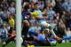 MANCHESTER, ENGLAND - OCTOBER 05: Sergio Aguero of Manchester City shoots past Sylvain Distin (R) and Tim Howard (L) of Everton to score his team's second goal during the Barclays Premier League match between Manchester City and Everton at Etihad Stadium