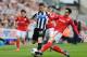 NEWCASTLE UPON TYNE, ENGLAND - MAY 03: Mathieu Debuchy of Newcastle United is tackled by Peter Whittingham of Cardiff City during the Barclays Premier League match between Newcastle United and Cardiff City at St James' Park on May 3, 2014 in Newcastle up
