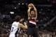 May 6, 2014; San Antonio, TX, USA; Portland Trail Blazers forward Nicolas Batum (88) shoots the ball over San Antonio Spurs forward Marco Belinelli (3) in game one of the second round of the 2014 NBA Playoffs at AT&T Center. Mandatory Credit: Soobum Im-US