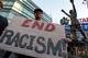 LOS ANGELES, CA - APRIL 29: Dexter McLeod holds a sign protesting racist comments made by L.A. Clippers owner Donald Sterling outside Staples Center before a playoff game on April 29, 2014 in Los Angeles, California. Clippers owner Donald Sterling was