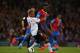 LONDON, ENGLAND - MAY 05: Glen Johnson of Liverpool and Yannick Bolasie of Crystal Palace compete for the ball during the Barclays Premier League match between Crystal Palace and Liverpool at Selhurst Park on May 5, 2014 in London, England. (Photo by Cl