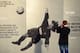 LONDON, ENGLAND - DECEMBER 08: An Arsenal fan takes a photo of a picture of former Arsenal goalkeeper David Seaman ahead of the Barclays Premier League match between Arsenal and Everton at Emirates Stadium on December 8, 2013 in London, England. (Photo b