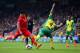 NORWICH, ENGLAND - APRIL 20: Luis Suarez of Liverpool is challenged by Bradley Johnson of Norwich City during the Barclays Premier League match between Norwich City and Liverpool at Carrow Road on April 20, 2014 in Norwich, England. (Photo by Jamie McDo