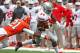 CHAMPAIGN, IL - NOVEMBER 16: Carlos Hyde #34 of the Ohio State Buckeyes breaks a tackle attempt by Zane Petty #21 of the Illinois Fighting Illini to score a touchdown at Memorial Stadium on November 16, 2013 in Champaign, Illinois. (Photo by Jonathan Dani