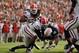 Nov 16, 2013; Auburn, AL, USA; Auburn Tigers running back Tre Mason (21) is tackled by Georgia Bulldogs linebacker Amarlo Herrera (52) during the first half at Jordan Hare Stadium. Mandatory Credit: Shanna Lockwood-USA TODAY Sports