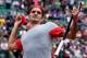 PARIS, FRANCE - MAY 25: Roger Federer of Switzerland throws his sweatband into the crowd as he celebrates victory in his men's singles match against Lukas Lacko of Slovakia on day one of the French Open at Roland Garros on May 25, 2014 in Paris, France.