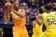 Mar 28, 2014; Indianapolis, IN, USA; Tennessee Volunteers forward Jarnell Stokes (5) looks to pass the ball away from Michigan Wolverines forward Jordan Morgan (52) and guard Derrick Walton Jr. (10) in the first half in the semifinals of the midwest regi