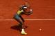 PARIS, FRANCE - MAY 28: Serena Williams of the United States returns a shot during her women's singles match against Garbine Muguruza of Spain on day four of the French Open at Roland Garros on May 28, 2014 in Paris, France. (Photo by Matthew Stockman/G