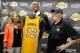 August 10, 2012; El Segundo, CA, USA; Los Angeles Lakers center Dwight Howard stands between Jeanie Buss and Jim Buss as he holds his jersey during a press conference held to introduce the three-time defensive player of the year who was aquired in a fou