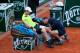 PARIS, FRANCE - MAY 31: Andy Murray of Great Britain receives assistance from the trainer during a break in his men's singles match against Philipp Kohlschreiber of Germany on day seven of the French Open at Roland Garros on May 31, 2014 in Paris, France