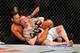 Feb 15, 2014; Jaragua do Sul, SC, Brazil; Charles Oliveira (red gloves) fights Andy Ogle (blue gloves) during UFC Fight Night Machida vs Mousasi at Arena Jaragua. Mandatory Credit: Jason Silva-USA TODAY Sports