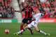BOURNEMOUTH, ENGLAND - JANUARY 25: Steven Gerrard of Liverpool tackles Lewis Grabban of Bournemouth during the FA Cup Fourth Round match between Bournemouth and Liverpool at Goldsands Stadium on January 25, 2014 in Bournemouth, England. (Photo by Ian Wa