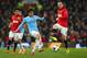 MANCHESTER, ENGLAND - MARCH 25: David Silva of Manchester City competes with Wayne Rooney of Manchester United during the Barclays Premier League match between Manchester United and Manchester City at Old Trafford on March 25, 2014 in Manchester, England