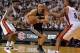 Jun 10, 2014; Miami, FL, USA; San Antonio Spurs guard Manu Ginobili (20) drives against Miami Heat guard Norris Cole (left) and forward Rashard Lewis (9) during the third quarter of game three of the 2014 NBA Finals at American Airlines Arena. Mandatory C