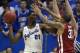 LAWRENCE, KS - FEBRUARY 24: Joel Embiid #21 of the Kansas Jayhawks looks to pass the ball against D.J. Bennett #31 of the Oklahoma Sooners in the second half at Allen Fieldhouse on February 24, 2014 in Lawrence, Kansas. Kansas won 83-75. (Photo by Ed Zu
