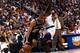 23 Apr 1998: Tim Duncan #21 of the San Antonio Spurs dribbles the ball around a player from the Phoenix Suns during a first round playoff game at the America West Arena in Phoenix, Arizona. The Spurs defeated the Suns 102-96. Mandatory Credit: Tom Hauck