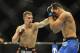 Feb 22, 2014; Las Vegas, NV, USA; Rory MacDonald (red gloves) lands a punch on Demian Maia (blue gloves) during their UFC welterweight bout at Mandalay Bay. MacDonald won by way of a 29-28 decision. Mandatory Credit: Stephen R. Sylvanie-USA TODAY Sports
