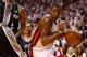 MIAMI, FL - JUNE 12: Mario Chalmers #15 of the Miami Heat drives to the basket against Tiago Splitter #22 of the San Antonio Spurs during Game Four of the 2014 NBA Finals at American Airlines Arena on June 12, 2014 in Miami, Florida. NOTE TO USER: User e