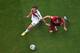SALVADOR, BRAZIL - JUNE 16: Joao Pereira of Portugal fouls Mario Goetze of Germany leading to a penalty kick during the 2014 FIFA World Cup Brazil Group G match between Germany and Portugal at Arena Fonte Nova on June 16, 2014 in Salvador, Brazil. (Phot