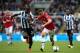 NEWCASTLE-UPON-TYNE, ENGLAND - APRIL 05: Adnan Januzaj of Manchester United battles with Cheik Ismael Tiote of Newcastle United during the Barclays Premier League match between Newcastle United and Manchester United at St James' Park on April 5, 2014 in