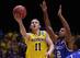 INDIANAPOLIS, IN - MARCH 30: Nik Stauskas #11 of the Michigan Wolverines shoots the ball against Aaron Harrison #2 of the Kentucky Wildcats during the midwest regional final of the 2014 NCAA Men's Basketball Tournament at Lucas Oil Stadium on March 30, 2