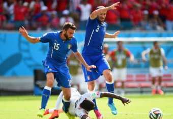 RECIFE, BRAZIL - JUNE 20: Joel Campbell of Costa Rica falls after a challenge by Giorgio Chiellini (L) and Andrea Barzagli of Italy during the 2014 FIFA World Cup Brazil Group D match between Italy and Costa Rica at Arena Pernambuco on June 20, 2014 in R