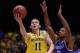 INDIANAPOLIS, IN - MARCH 30: Nik Stauskas #11 of the Michigan Wolverines shoots the ball against Aaron Harrison #2 of the Kentucky Wildcats during the midwest regional final of the 2014 NCAA Men's Basketball Tournament at Lucas Oil Stadium on March 30, 2