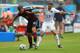 RECIFE, BRAZIL - JUNE 26: Lukas Podolski of Germany is challenged by Graham Zusi of the United States during the 2014 FIFA World Cup Brazil group G match between the United States and Germany at Arena Pernambuco on June 26, 2014 in Recife, Brazil. (Photo