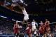 Mar 21, 2014; St. Louis, MO, USA; Kansas Jayhawks guard Andrew Wiggins (22) dunks the ball ahead of Eastern Kentucky Colonels guard Isaac McGlone (5), Glenn Cosey (0) and Marcus Lewis (12) in the first half during the 2nd round of the 2014 NCAA Men's Bask
