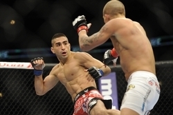 Jan 26, 2013; Chicago, IL, USA; Ricardo Lamas (red and black shorts) fights against Erik Koch (white shorts) during UFC on FOX 6 at the United Center.  Mandatory Credit: David Banks-USA TODAY Sports