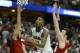 Mar 29, 2014; Anaheim, CA, USA; Arizona Wildcats forward Rondae Hollis-Jefferson (center) shoots the ball against Wisconsin Badgers forward Sam Dekker (15) and forward Frank Kaminsky (44) during the second half in the finals of the west regional of the 20