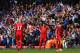 LIVERPOOL, ENGLAND - APRIL 27: A dejected Martin Skrtel, Steven Gerrard and Joe Allen of Liverpool look on as the Chelsea fans celebrate after Willian of Chelsea scored their second goal during the Barclays Premier League match between Liverpool and Che