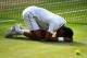 LONDON, ENGLAND - JULY 06: Novak Djokovic of Serbia falls to the floor as he celebrates winning the Gentlemen's Singles Final match against Roger Federer of Switzerland on day thirteen of the Wimbledon Lawn Tennis Championships at the All England Lawn Te