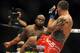 Jul 6, 2014; Las Vegas, NV, USA; Derrick Lewis (red gloves) goes in for a blow to Guto Inocente (blue gloves) during a heavyweight fight at Mandalay Bay Events Center. Mandatory Credit: Stephen R. Sylvanie-USA TODAY Sports