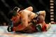 Jul 6, 2014; Las Vegas, NV, USA; Daniel Spohn (blue gloves) is pinned down by Patrick Walsh (red gloves) during a light heavyweight fight at Mandalay Bay Events Center. Mandatory Credit: Stephen R. Sylvanie-USA TODAY Sports