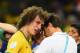BELO HORIZONTE, BRAZIL - JULY 08: David Luiz of Brazil is consoled after a 7-1 defeat to Germany during the 2014 FIFA World Cup Brazil Semi Final match between Brazil and Germany at Estadio Mineirao on July 8, 2014 in Belo Horizonte, Brazil. (Photo by B