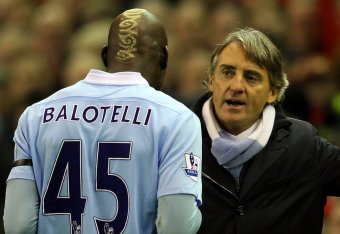 LIVERPOOL, ENGLAND - NOVEMBER 27:  Manchester City Manager Roberto Mancini speaks to Mario Balotelli as he heads for the dressing room after being sent off during the Barclays Premier League match between Liverpool and Manchester City at Anfield on Novemb