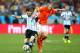 SAO PAULO, BRAZIL - JULY 09: Lionel Messi of Argentina is challenged by Ron Vlaar of the Netherlands during the 2014 FIFA World Cup Brazil Semi Final match between the Netherlands and Argentina at Arena de Sao Paulo on July 9, 2014 in Sao Paulo, Brazil.
