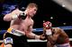 Alvarez used a sharp uppercut to open a cut on Lara.