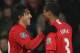 MANCHESTER, UNITED KINGDOM - DECEMBER 08: Carlos Tevez of Manchester United is congratulated by team mate Patrice Evra (R) after scoring the second goal during the Barclays Premier League match between Manchester United and Derby County at Old Trafford o
