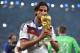 RIO DE JANEIRO, BRAZIL - JULY 13: Sami Khedira of Germany kisses the World Cup trophy after defeating Argentina 1-0 in extra time during the 2014 FIFA World Cup Brazil Final match between Germany and Argentina at Maracana on July 13, 2014 in Rio de Jane
