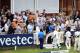 Ishant Sharma (in blue) leads India back to the dressing room after a historic win.