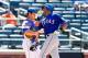 NEW YORK, NY - JULY 06: Alex Rios #51 of the Texas Rangers celebrates his eighth inning home run as Anthony Recker #20 of the New York Mets looks on at Citi Field on July 6, 2014 in the Flushing neighborhood of the Queens borough of New York City. (Phot