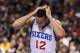 Jan 27, 2014; Philadelphia, PA, USA; Philadelphia 76ers guard Evan Turner (12) grabs his head after being hit during the fourth quarter against the Phoenix Suns at the Wells Fargo Center. The Suns defeated the Sixers 124-113. Mandatory Credit: Howard Smit