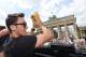 BERLIN, GERMANY - JULY 15: Mesut Oezil celebrates on the open top bus at the German team victory ceremony on July 15, 2014 in Berlin, Germany. Germany won the 2014 FIFA World Cup Brazil match against Argentina in Rio de Janeiro on July 13. (Photo by Mark