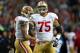 SEATTLE, WA - JANUARY 19: (R-L) Guard Alex Boone #75 smiles alongisde quarterback Colin Kaepernick #7 of the San Francisco 49ers in the first half against the Seattle Seahawks during the 2014 NFC Championship at CenturyLink Field on January 19, 2014 in S