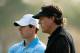 ABU DHABI, UNITED ARAB EMIRATES - JANUARY 16: Rory McIlroy of Northern Ireland (L) waits on the 16th green with Phil Mickelson of the USA during the first round of the Abu Dhabi HSBC Golf Championship at the Abu Dhabi Golf Clubon January 16, 2014 in Abu