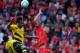 LIVERPOOL, ENGLAND - AUGUST 10: Dejan Lovren (R) of Liverpool and Pierre Emerick Aubameyang (L) of Borussia Dortmund contest a header during the Pre Season Friendly match between Liverpool and Borussia Dortmund at Anfield on August 10, 2014 in Liverpool,